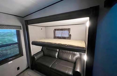 Kenora Resort | RV 5 Rustic Charm w/Queen Bed with Forest Background